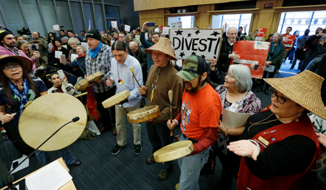 Native drummers at the meeting where the Seattle City Council voted to divest in February. Photo: AP
